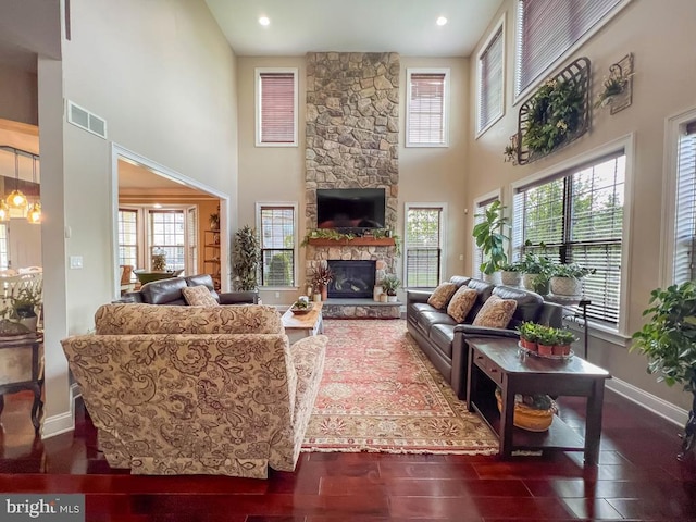 414 Saint James Ct, Langhorne, PA 19047 - living area with a towering ceiling, plenty of natural light, a stone fireplace, baseboards, and dark wood-type flooring