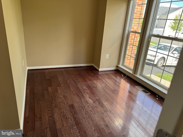 42435 Ibex Dr, Sterling, VA 20166 - spare room with plenty of natural light, dark wood-type flooring, and baseboards