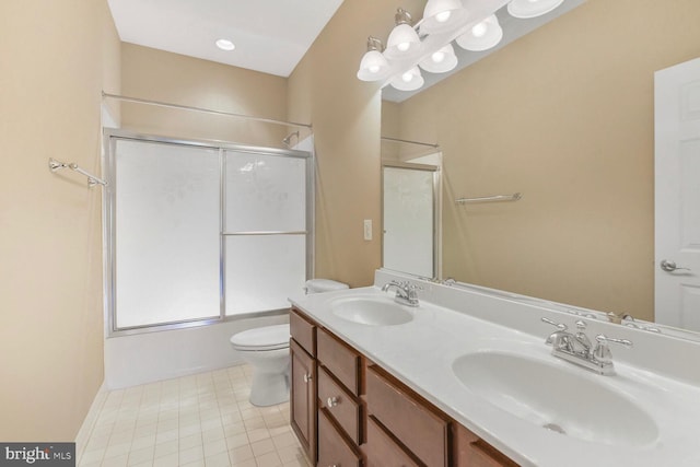 42435 Ibex Dr, Sterling, VA 20166 - bathroom with toilet, double vanity, enclosed tub / shower combo, and tile patterned flooring