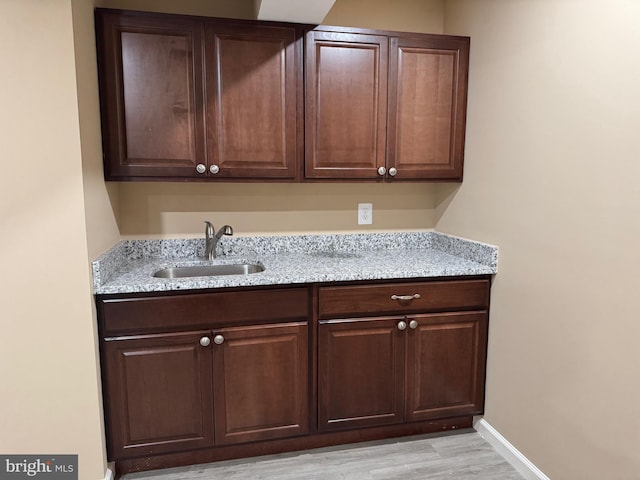 42435 Ibex Dr, Sterling, VA 20166 - laundry room featuring a sink, light wood-style flooring, and baseboards