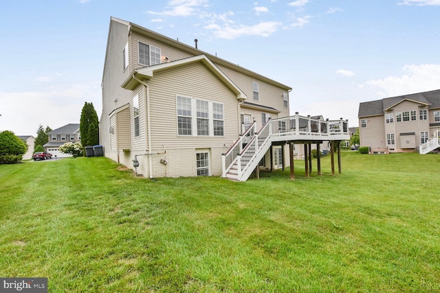 42435 Ibex Dr, Sterling, VA 20166 - rear view of house with a wooden deck, stairs, and a lawn