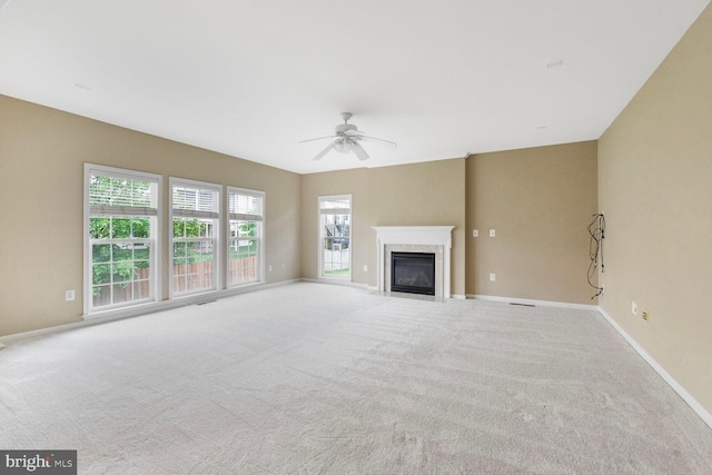 42435 Ibex Dr, Sterling, VA 20166 - unfurnished living room featuring a ceiling fan, baseboards, light colored carpet, and a fireplace
