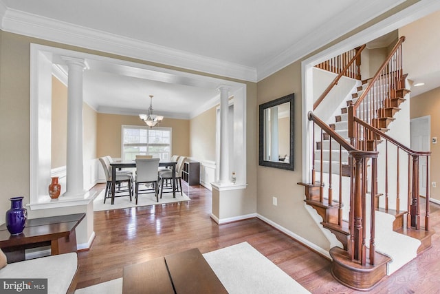42435 Ibex Dr, Sterling, VA 20166 - living room with wood finished floors, baseboards, decorative columns, stairway, and crown molding