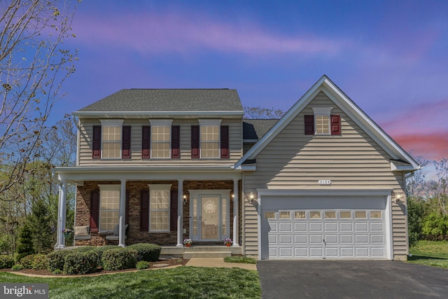 5194 Longbow Rd, King George, VA 22485 - view of front of house featuring asphalt driveway, a porch, roof with shingles, a front yard, and an attached garage