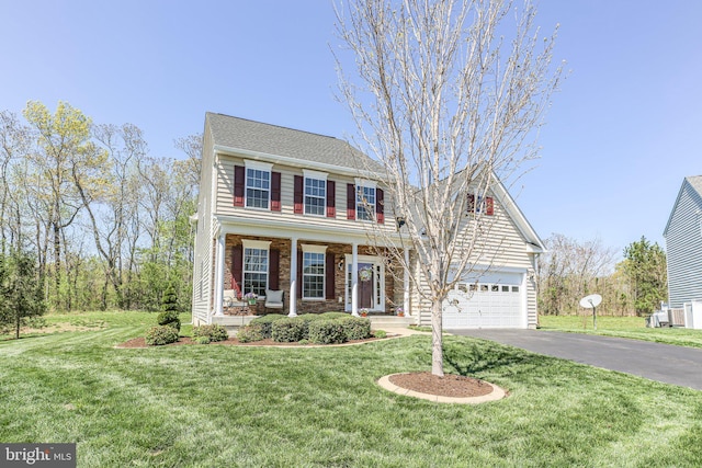 5194 Longbow Rd, King George, VA 22485 - view of front of property with driveway, covered porch, a garage, and a front lawn