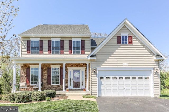 5194 Longbow Rd, King George, VA 22485 - view of front of house with driveway, a porch, a shingled roof, and a garage