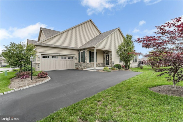 217 Honeycroft Blvd, Cochranville, PA 19330 - view of front facade featuring stone siding, driveway, a shingled roof, a garage, and a front yard