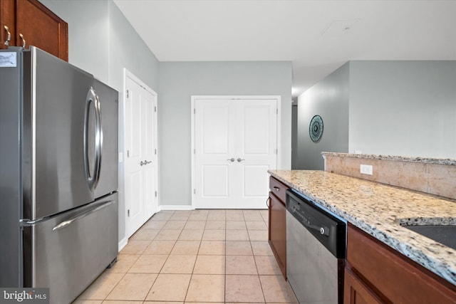 113 E Main St Unit 303, Newark, DE 19711 - kitchen with appliances with stainless steel finishes, light tile patterned floors, and light stone counters