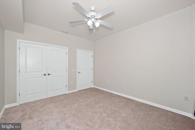 113 E Main St Unit 303, Newark, DE 19711 - unfurnished bedroom featuring carpet, a closet, and ceiling fan
