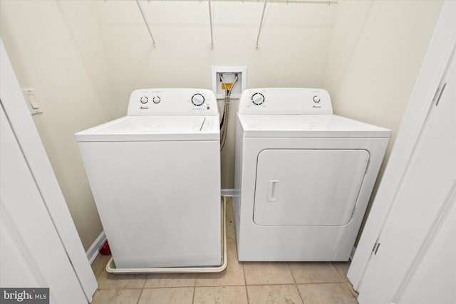 113 E Main St Unit 303, Newark, DE 19711 - laundry room featuring washer and dryer and light tile patterned floors