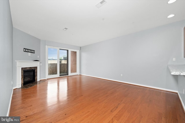 113 E Main St Unit 303, Newark, DE 19711 - unfurnished living room featuring wood finished floors, a fireplace, and recessed lighting