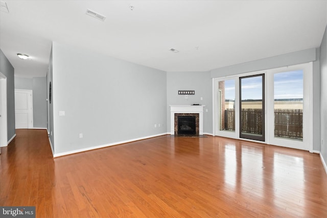 113 E Main St Unit 303, Newark, DE 19711 - unfurnished living room with wood finished floors and a premium fireplace