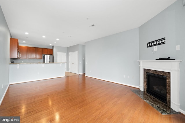 113 E Main St Unit 303, Newark, DE 19711 - unfurnished living room with a fireplace, light wood finished floors, and recessed lighting