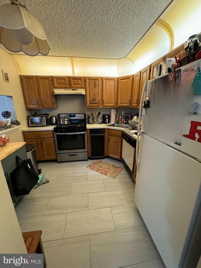 31 Kite Ct, Trenton, NJ 08648 - kitchen with white appliances, a sink, light countertops, brown cabinetry, and a textured ceiling