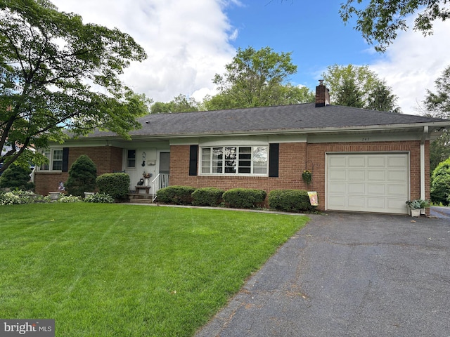 243 Park Ave, Mount Joy, PA 17552 - ranch-style home featuring brick siding, a front lawn, a garage, and asphalt driveway