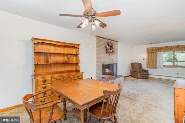 243 Park Ave, Mount Joy, PA 17552 - dining space with a baseboard heating unit, carpet floors, a fireplace, a ceiling fan, and baseboards