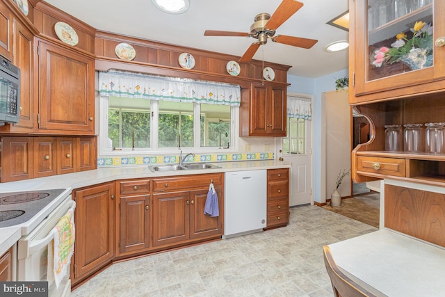 243 Park Ave, Mount Joy, PA 17552 - kitchen featuring a sink, white appliances, light countertops, ceiling fan, and brown cabinetry