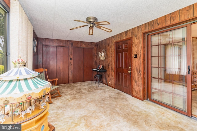 243 Park Ave, Mount Joy, PA 17552 - entrance foyer with carpet flooring, a ceiling fan, wooden walls, and healthy amount of natural light