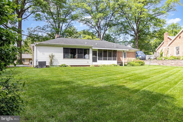 243 Park Ave, Mount Joy, PA 17552 - rear view of house with a yard, a sunroom, central AC unit, and a chimney