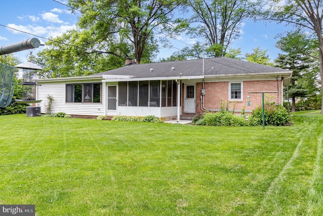 243 Park Ave, Mount Joy, PA 17552 - rear view of property featuring a sunroom, a yard, a chimney, brick siding, and central AC