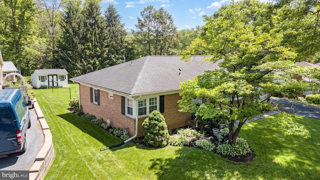 243 Park Ave, Mount Joy, PA 17552 - view of home's exterior featuring brick siding, a lawn, and roof with shingles