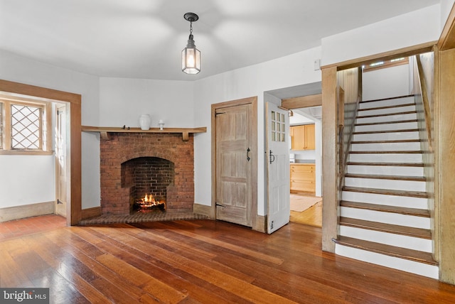 8515 Seminole St, Philadelphia, PA 19118 - unfurnished living room featuring hardwood / wood-style flooring, a fireplace, stairway, and baseboards