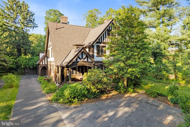 8515 Seminole St, Philadelphia, PA 19118 - view of front of home with a shingled roof and a chimney