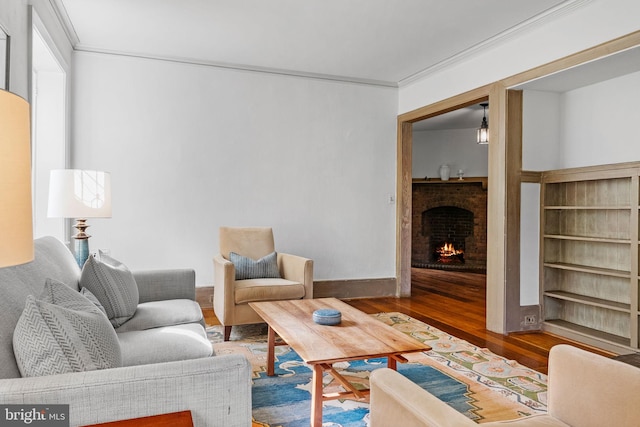 8515 Seminole St, Philadelphia, PA 19118 - living room with wood finished floors, a brick fireplace, crown molding, and baseboards