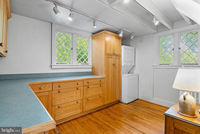 8515 Seminole St, Philadelphia, PA 19118 - laundry area with track lighting, stacked washer / dryer, and light wood-type flooring