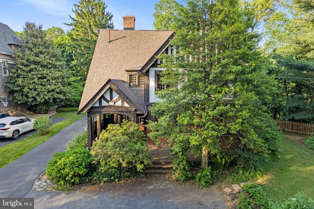 8515 Seminole St, Philadelphia, PA 19118 - view of front of house with a shingled roof and a chimney