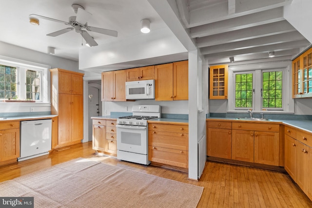 8515 Seminole St, Philadelphia, PA 19118 - kitchen with white appliances, a sink, light wood-type flooring, and glass insert cabinets
