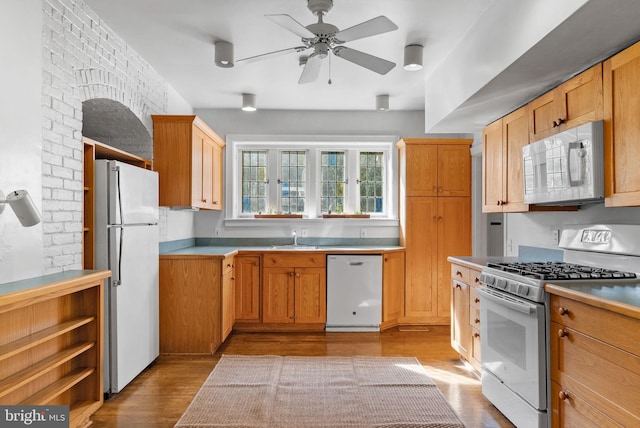 8515 Seminole St, Philadelphia, PA 19118 - kitchen with white appliances, light wood-style flooring, ceiling fan, a sink, and light countertops