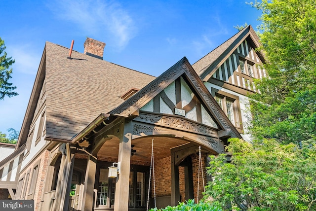 8515 Seminole St, Philadelphia, PA 19118 - back of property with a shingled roof, a chimney, and brick siding