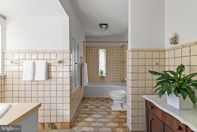 8515 Seminole St, Philadelphia, PA 19118 - bathroom featuring tile walls, vanity, toilet,  shower combination, and a wainscoted wall