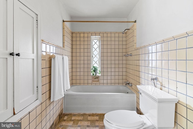 8515 Seminole St, Philadelphia, PA 19118 - full bathroom with tile walls, toilet, shower / tub combination, and wainscoting