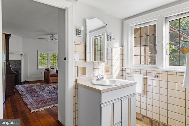 8515 Seminole St, Philadelphia, PA 19118 - bathroom featuring vanity, tile walls, ceiling fan, healthy amount of natural light, and wood finished floors