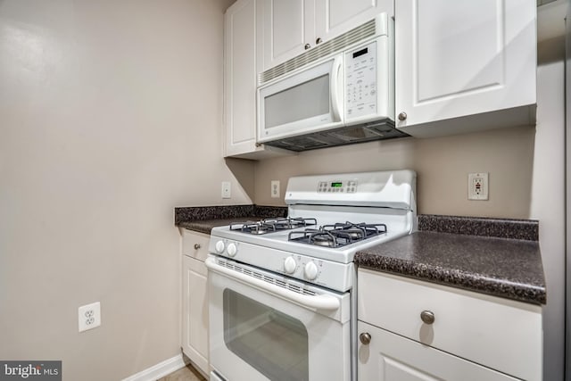 9486 Virginia Center Blvd Unit 316, Vienna, VA 22181 - kitchen with white appliances, dark countertops, and white cabinetry