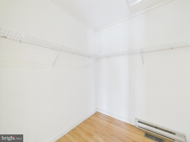 423 W Market St, Georgetown, DE 19947 - spacious closet with wood finished floors and a baseboard heating unit
