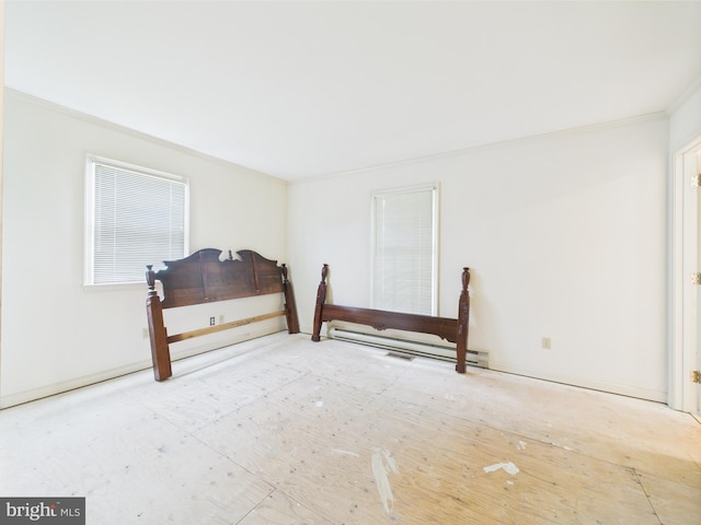 423 W Market St, Georgetown, DE 19947 - bedroom with ornamental molding and a baseboard heating unit