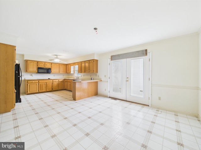 423 W Market St, Georgetown, DE 19947 - kitchen featuring black appliances, light countertops, a peninsula, french doors, and crown molding