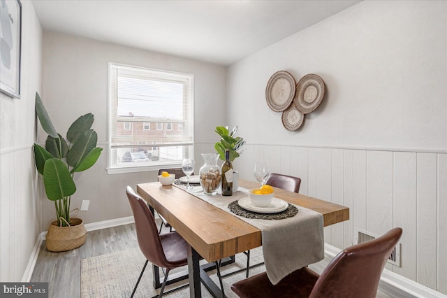 7509 Durwood Rd, Baltimore, MD 21222 - dining room with wood finished floors, baseboards, and wooden walls