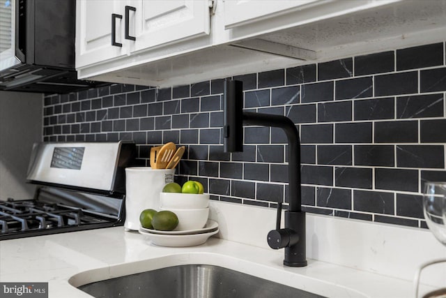 7509 Durwood Rd, Baltimore, MD 21222 - kitchen view of backsplash, white cabinets, and a sink