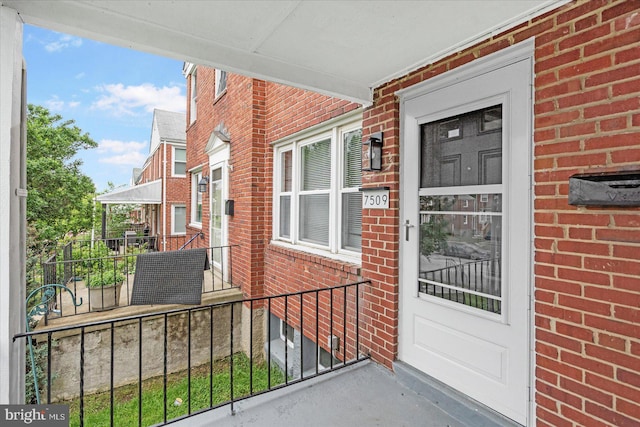 7509 Durwood Rd, Baltimore, MD 21222 - view of exterior entry featuring brick siding and a porch