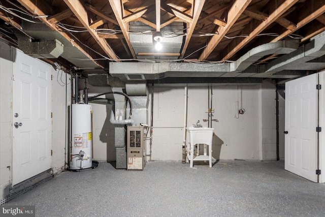7509 Durwood Rd, Baltimore, MD 21222 - unfinished below grade area featuring water heater, heating unit, and concrete block wall