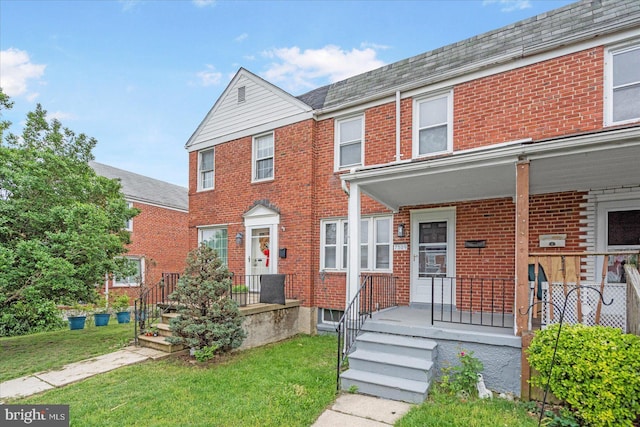 7509 Durwood Rd, Baltimore, MD 21222 - multi unit property with brick siding, a front lawn, and covered porch
