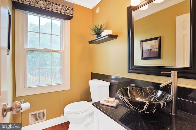 6034 Burnside Landing Dr, Burke, VA 22015 - half bathroom with toilet, crown molding, vanity, baseboards, and wood finished floors