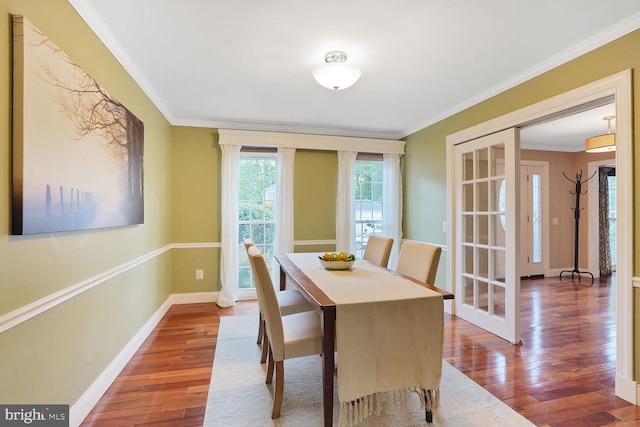 6034 Burnside Landing Dr, Burke, VA 22015 - dining room featuring wood finished floors, baseboards, and crown molding