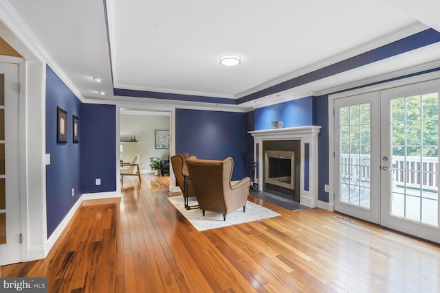 6034 Burnside Landing Dr, Burke, VA 22015 - living area with hardwood / wood-style floors, a tray ceiling, crown molding, baseboards, and a fireplace with flush hearth