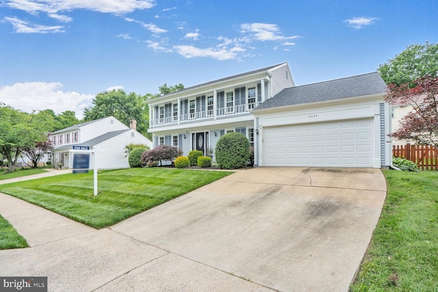 6034 Burnside Landing Dr, Burke, VA 22015 - colonial home with an attached garage, a balcony, and concrete driveway