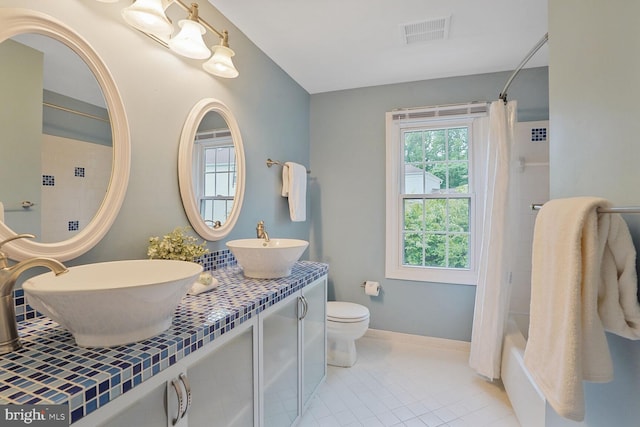 6034 Burnside Landing Dr, Burke, VA 22015 - bathroom featuring shower / bath combo with shower curtain, tile patterned flooring, toilet, double vanity, and baseboards